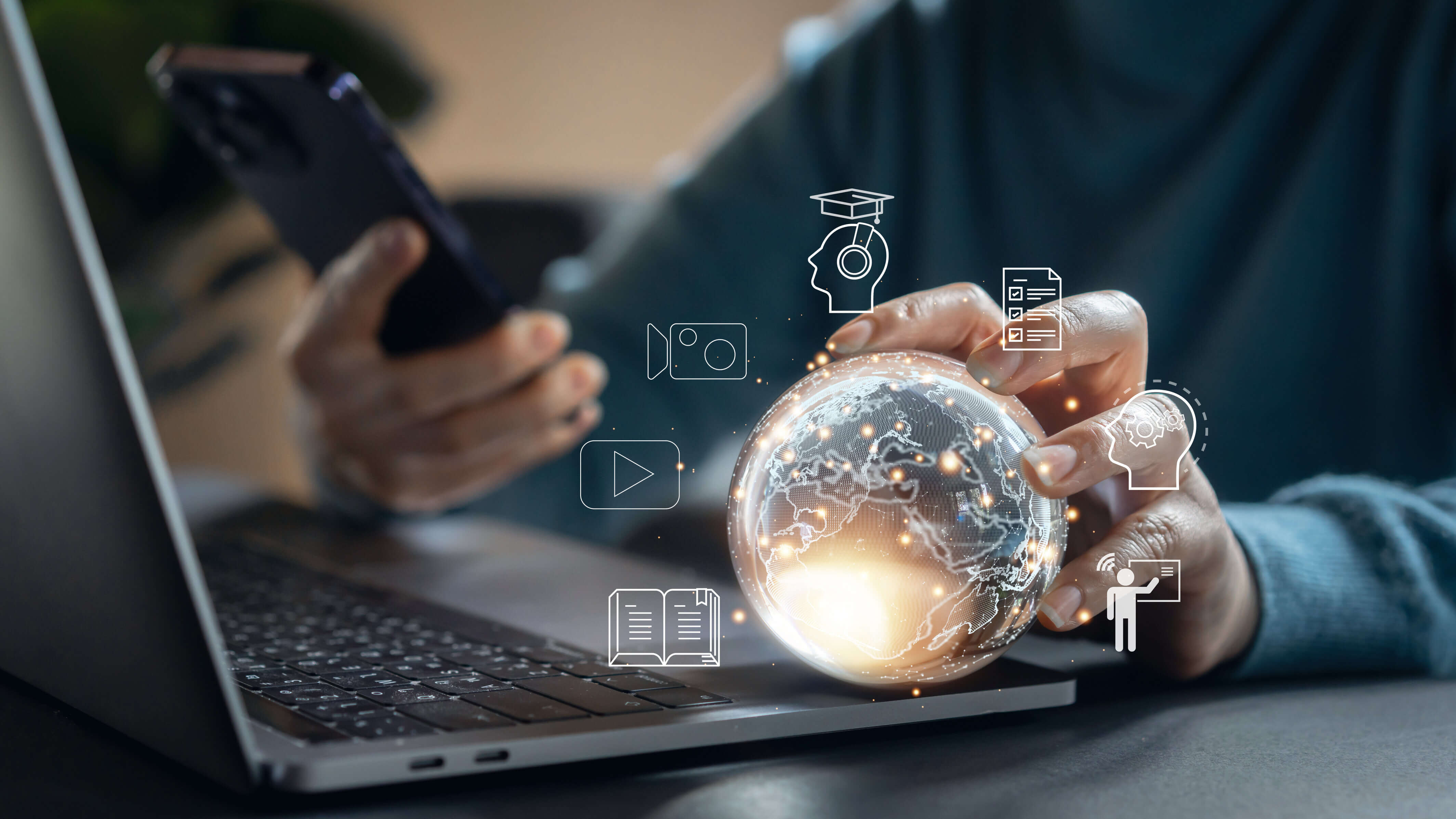 Hands holding a smartphone and a glowing globe, with digital education icons surrounding it.