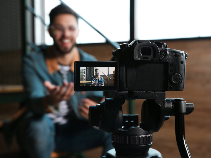 Young blogger recording video indoors