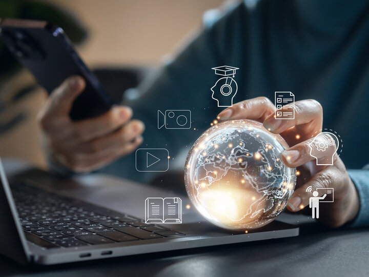 Guy with globe at his desk.